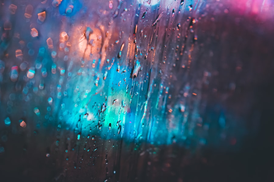 Raindrops on a window pane with blurred city lights behind